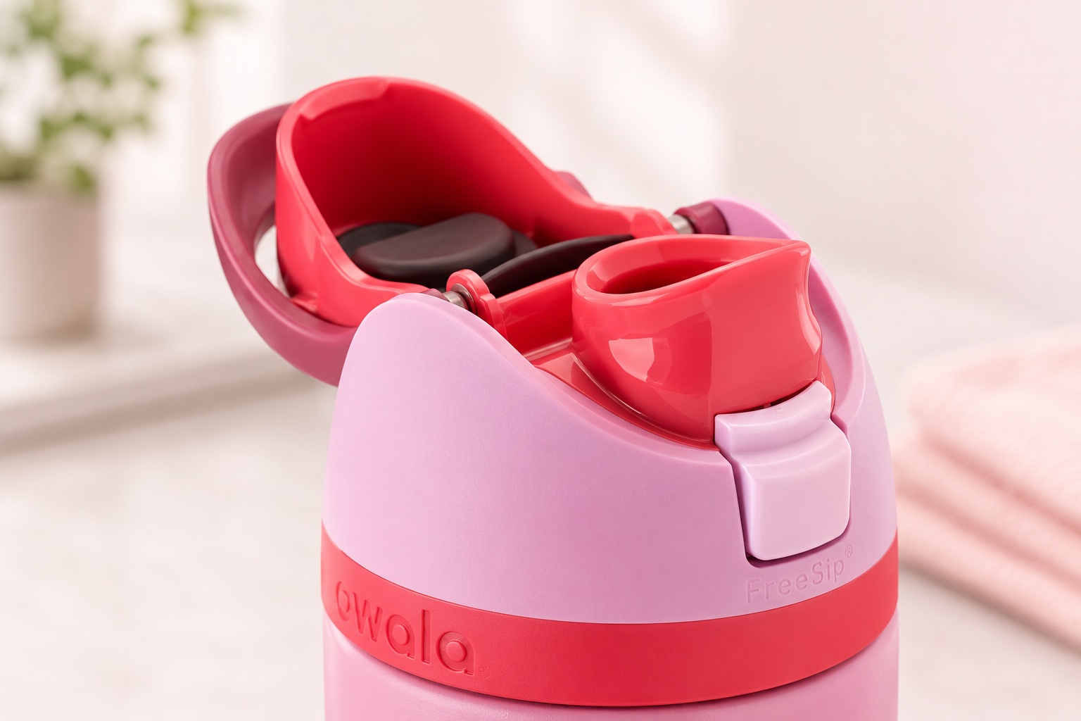 Close-up view of the pink dual-drinking FreeSip bottle lid